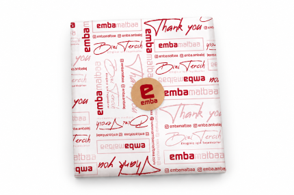 Beyaz fonda Emba logolu baskılı pelur kağıdıyla sarılmış paket